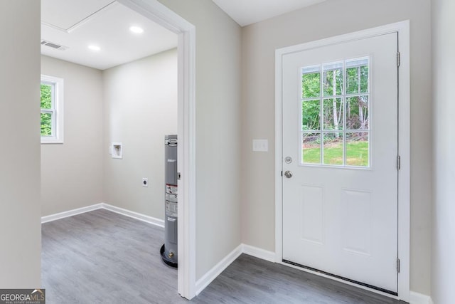 entryway with wood-type flooring, plenty of natural light, and electric water heater