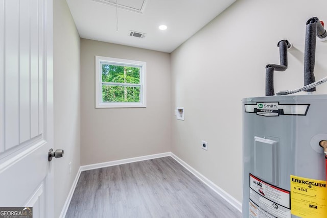 washroom with washer hookup, hookup for an electric dryer, light wood-type flooring, and water heater