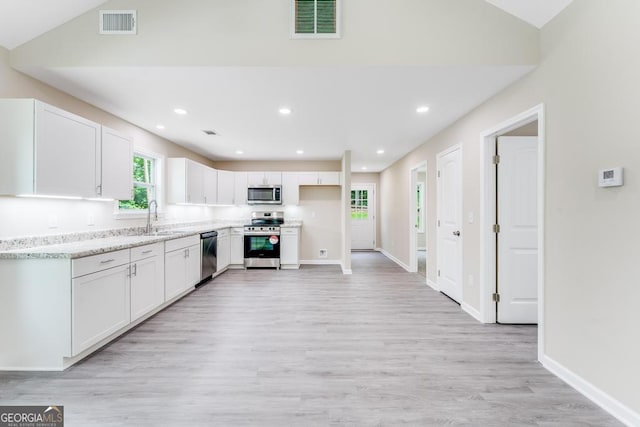 kitchen with appliances with stainless steel finishes, light hardwood / wood-style floors, white cabinetry, and sink