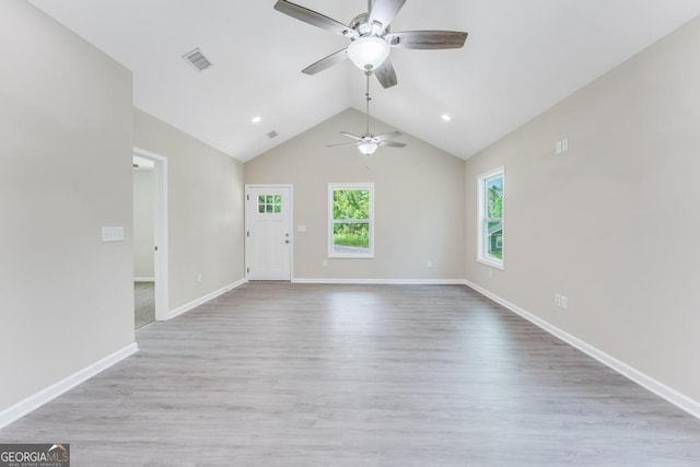 spare room featuring lofted ceiling, ceiling fan, and light hardwood / wood-style flooring