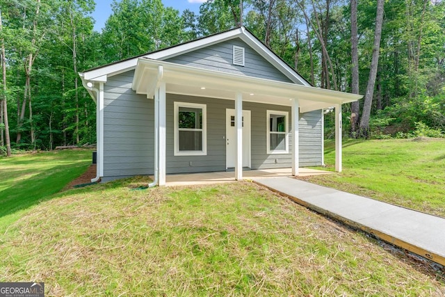 bungalow featuring a porch and a front lawn