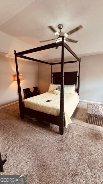 unfurnished bedroom featuring a textured ceiling, ceiling fan, carpet floors, and lofted ceiling