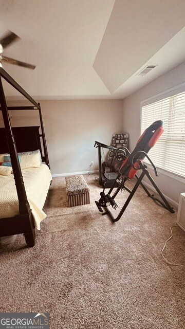 exercise area with ceiling fan and carpet flooring