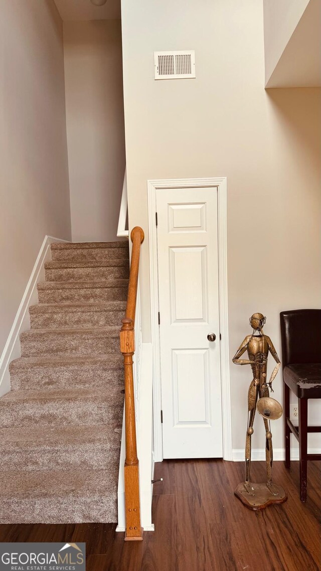 staircase featuring hardwood / wood-style floors