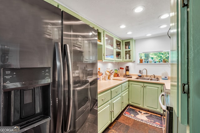 kitchen featuring green cabinets, sink, a textured ceiling, and stainless steel refrigerator with ice dispenser