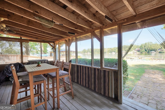 sunroom / solarium featuring lofted ceiling and a healthy amount of sunlight