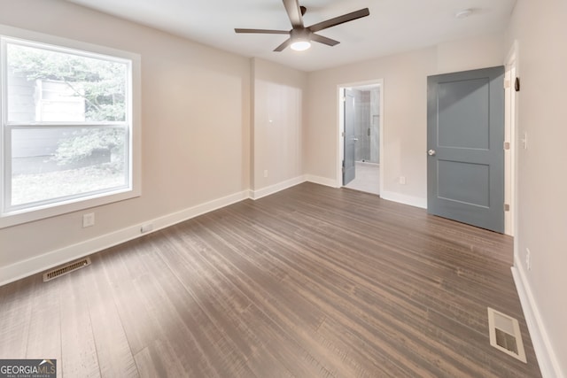 spare room with ceiling fan and dark hardwood / wood-style floors