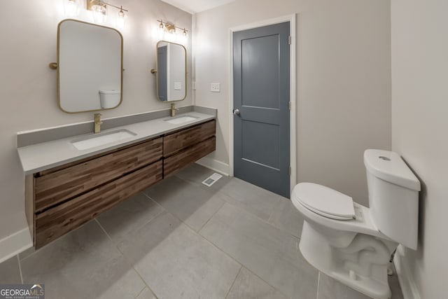 bathroom featuring vanity, toilet, and tile patterned flooring