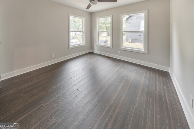 unfurnished room featuring ceiling fan and dark hardwood / wood-style floors