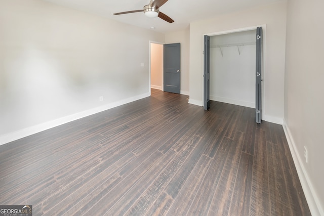 unfurnished bedroom with ceiling fan, a closet, and dark hardwood / wood-style flooring