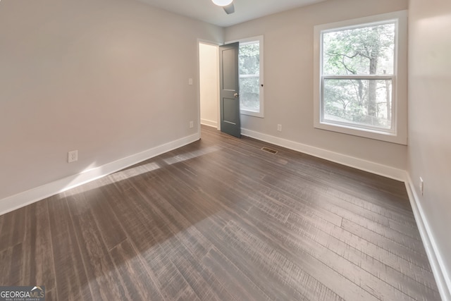 empty room with dark hardwood / wood-style floors