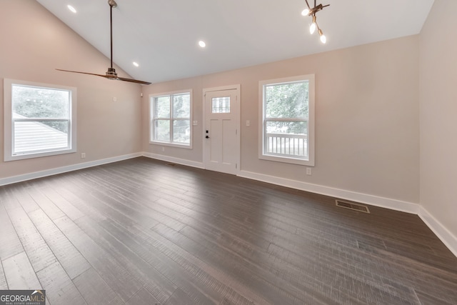 interior space featuring dark wood-type flooring, vaulted ceiling, and ceiling fan