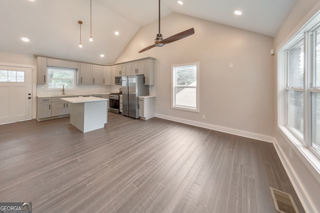 kitchen featuring plenty of natural light, a kitchen island, ceiling fan, and dark hardwood / wood-style flooring