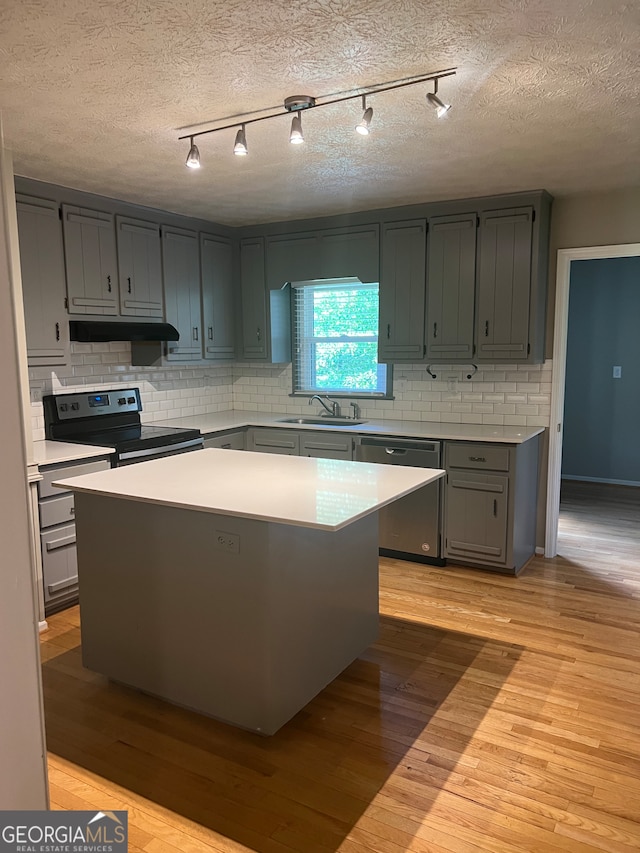 kitchen featuring appliances with stainless steel finishes, gray cabinetry, and light hardwood / wood-style floors