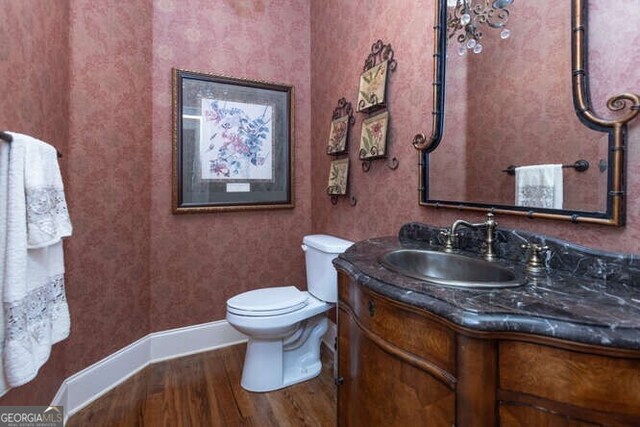 bathroom featuring hardwood / wood-style floors, toilet, and vanity