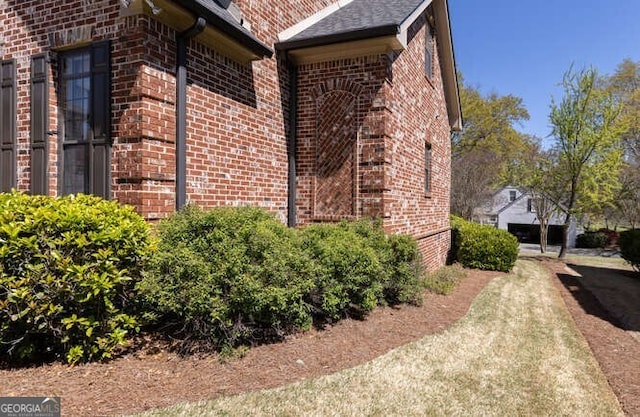 view of side of property with brick siding