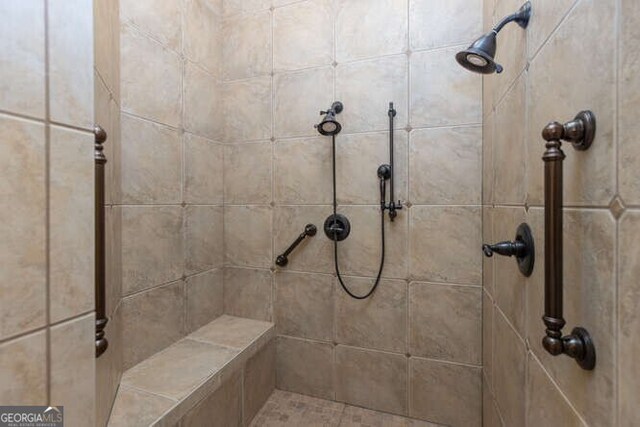 bathroom with a tile shower