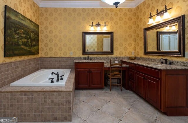 bathroom with crown molding, vanity, tiled tub, and tile patterned floors