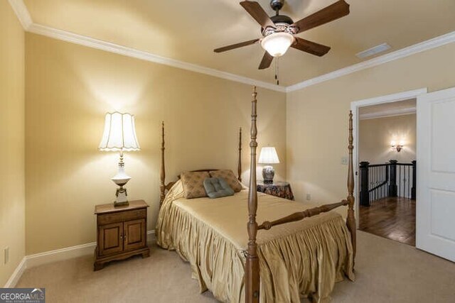 bedroom with light carpet, ceiling fan, and crown molding