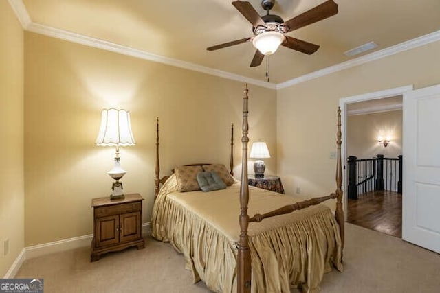 bedroom featuring visible vents, baseboards, light colored carpet, and ornamental molding