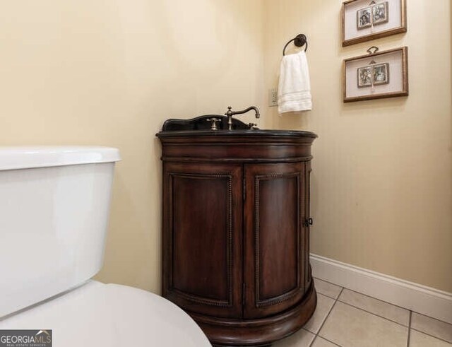 interior space with tile patterned floors, toilet, and vanity