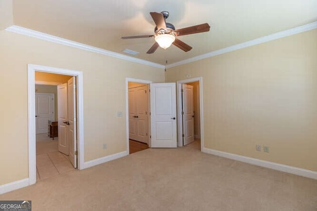 unfurnished bedroom featuring light carpet, ornamental molding, and ceiling fan