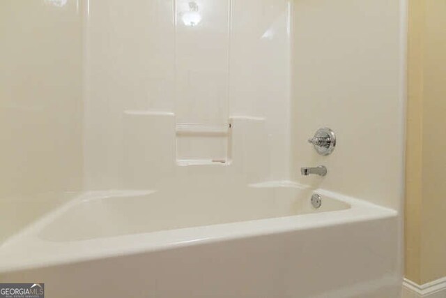 bathroom with bathing tub / shower combination