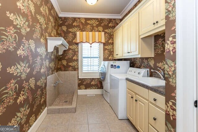 washroom with cabinets, independent washer and dryer, ornamental molding, light tile patterned floors, and sink