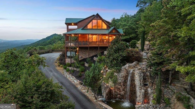 back house at dusk with a mountain view