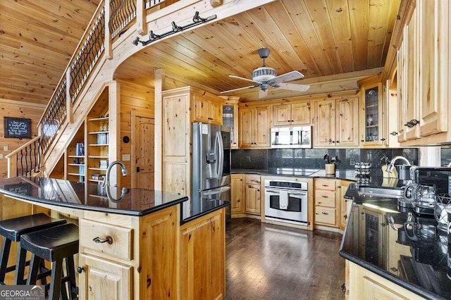 kitchen with light brown cabinetry, sink, dark wood-type flooring, ceiling fan, and appliances with stainless steel finishes