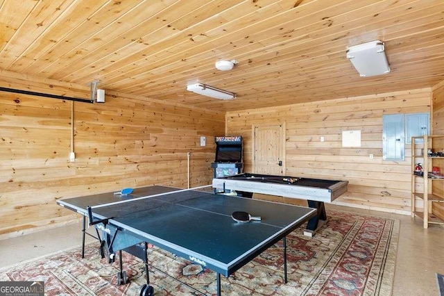 recreation room featuring wood walls, concrete floors, and wooden ceiling