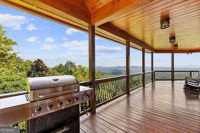 deck with a mountain view and area for grilling