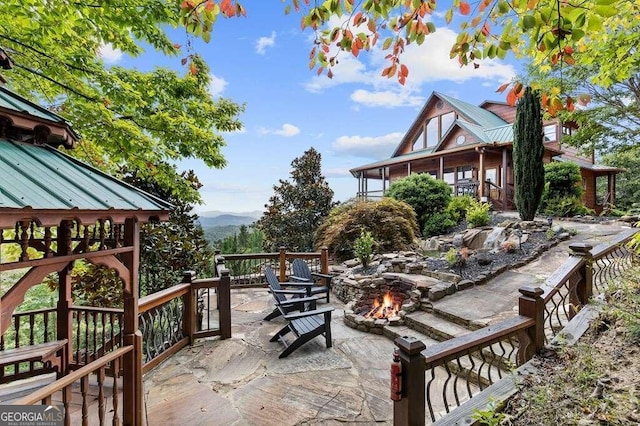 view of patio / terrace featuring a fire pit and a mountain view