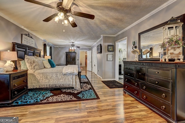 bedroom featuring crown molding, light hardwood / wood-style flooring, ceiling fan, and a textured ceiling