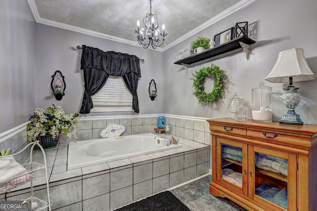 bathroom with a notable chandelier, tiled tub, ornamental molding, and a textured ceiling