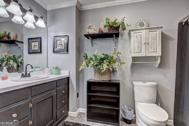 bathroom featuring toilet, ornamental molding, and vanity