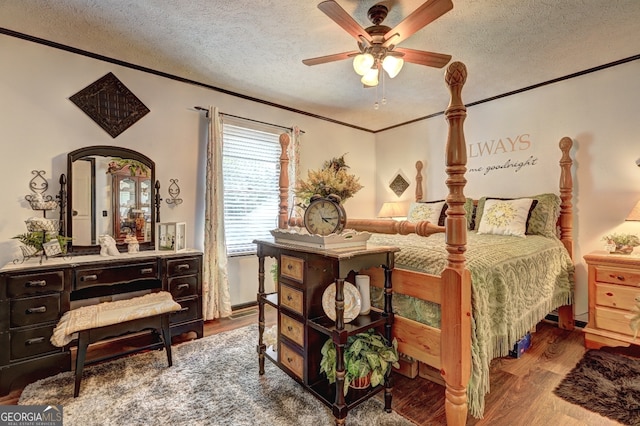 bedroom featuring ornamental molding, a textured ceiling, hardwood / wood-style flooring, and ceiling fan