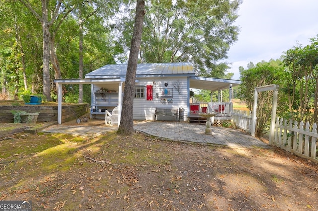 rear view of house featuring a wooden deck