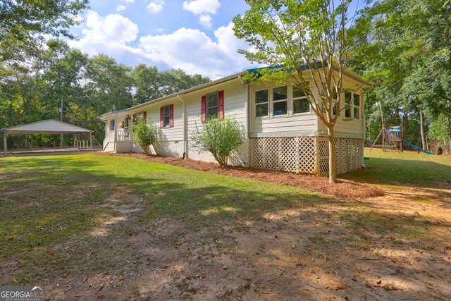 single story home featuring a playground and a front lawn