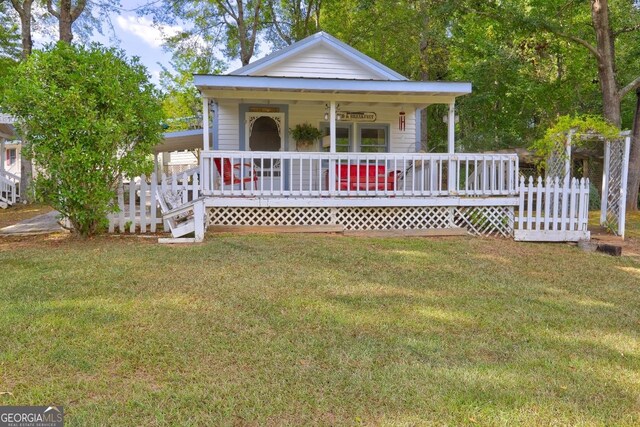 view of front of house with a front yard and a porch