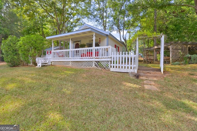 view of front facade with a deck and a front yard