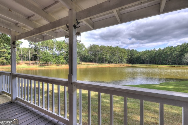 wooden deck featuring a water view and a yard