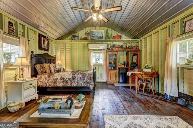 bedroom with lofted ceiling, a wall mounted AC, ceiling fan, and dark hardwood / wood-style floors