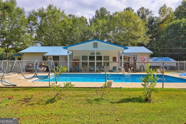 view of swimming pool with a patio area and a yard