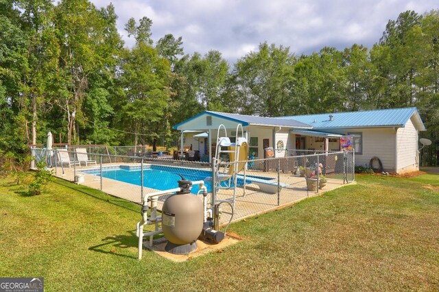 view of swimming pool with a yard and a patio