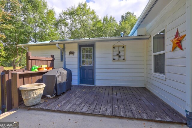 wooden deck with a grill