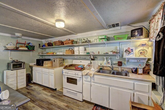 kitchen featuring hardwood / wood-style flooring, white cabinetry, sink, white range, and a textured ceiling