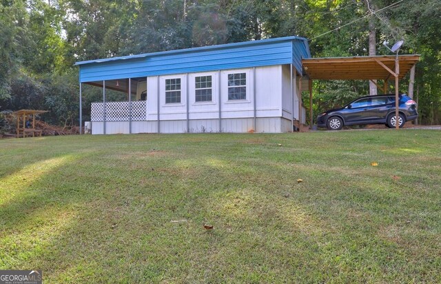 exterior space with a yard and a carport