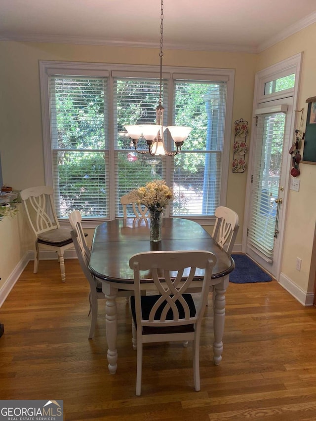 2631 Gladstone Ter, Woodstock, GA 30189 - dining area featuring ornamental molding, a notable chandelier, light wood finished floors, and baseboards