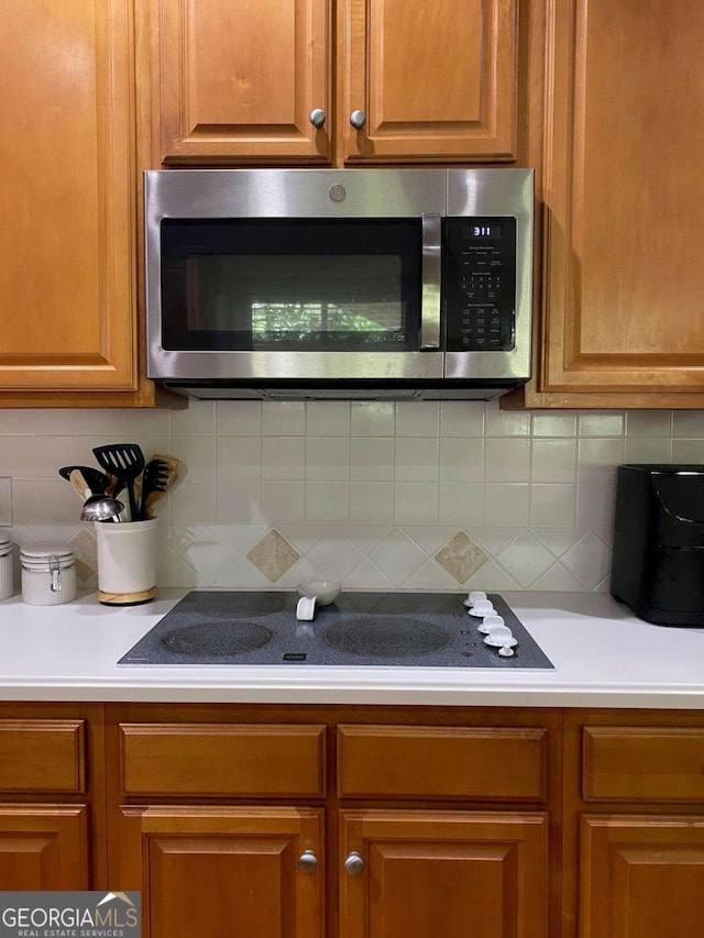 kitchen featuring backsplash and black electric cooktop